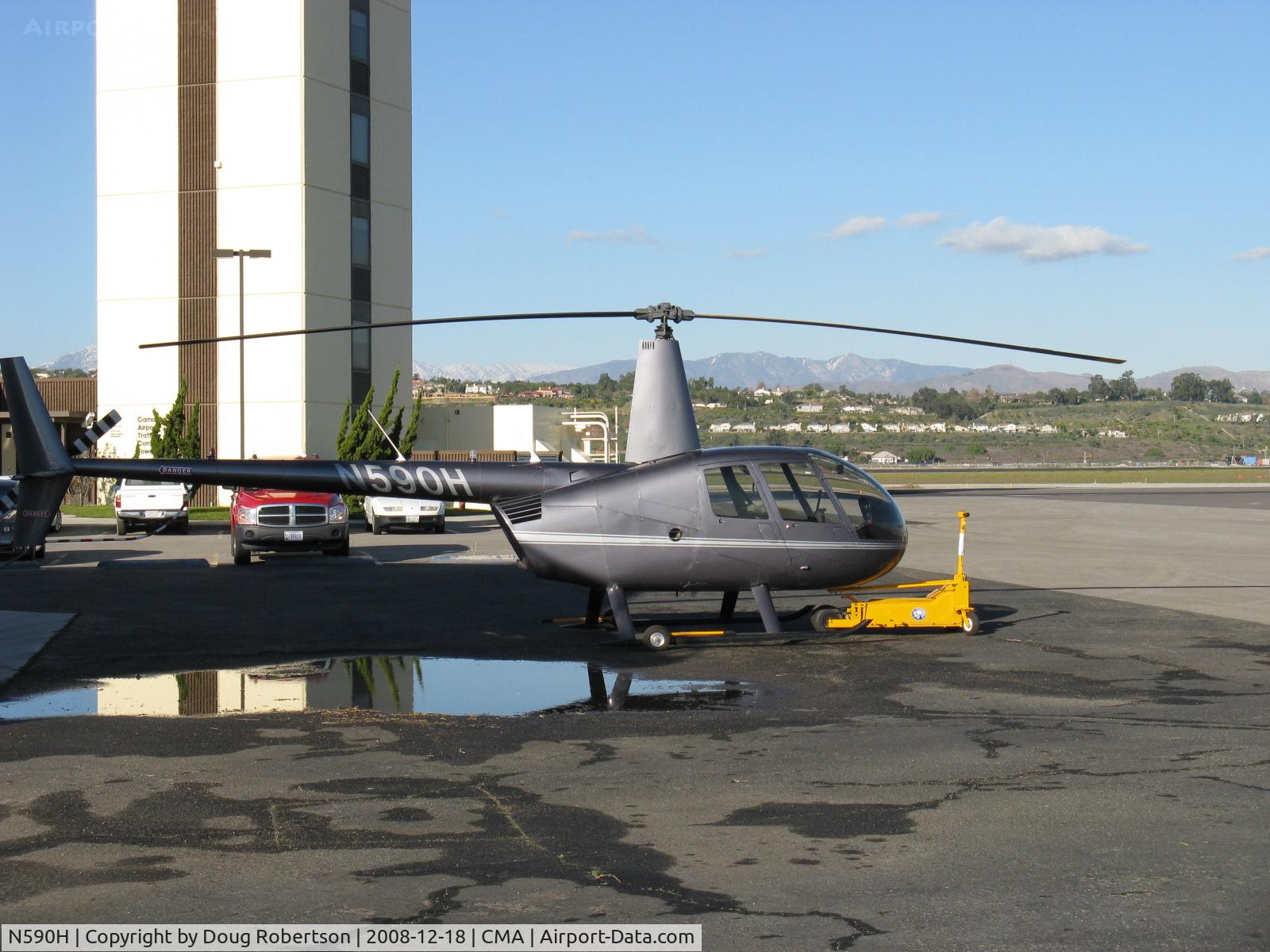 N590H, 2008 Robinson R44 Raven II C/N 12474, 2008 Robinson R44 RAVEN II, Lycoming IO-540-AE1A5 245 Hp for 5 minutes derated to 205 Hp continuous, at Orbic's ramp. CMA's Air Traffic Control Tower behind.