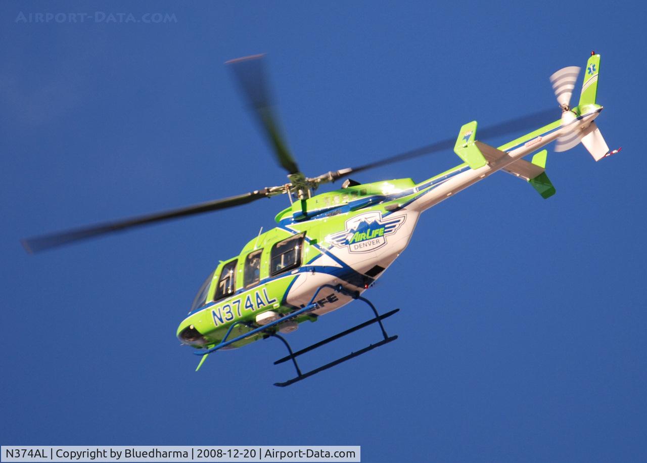 N374AL, 2008 Bell 407 C/N 53819, AirLife Denver heading West over Columbine High School Littleton, Colorado.