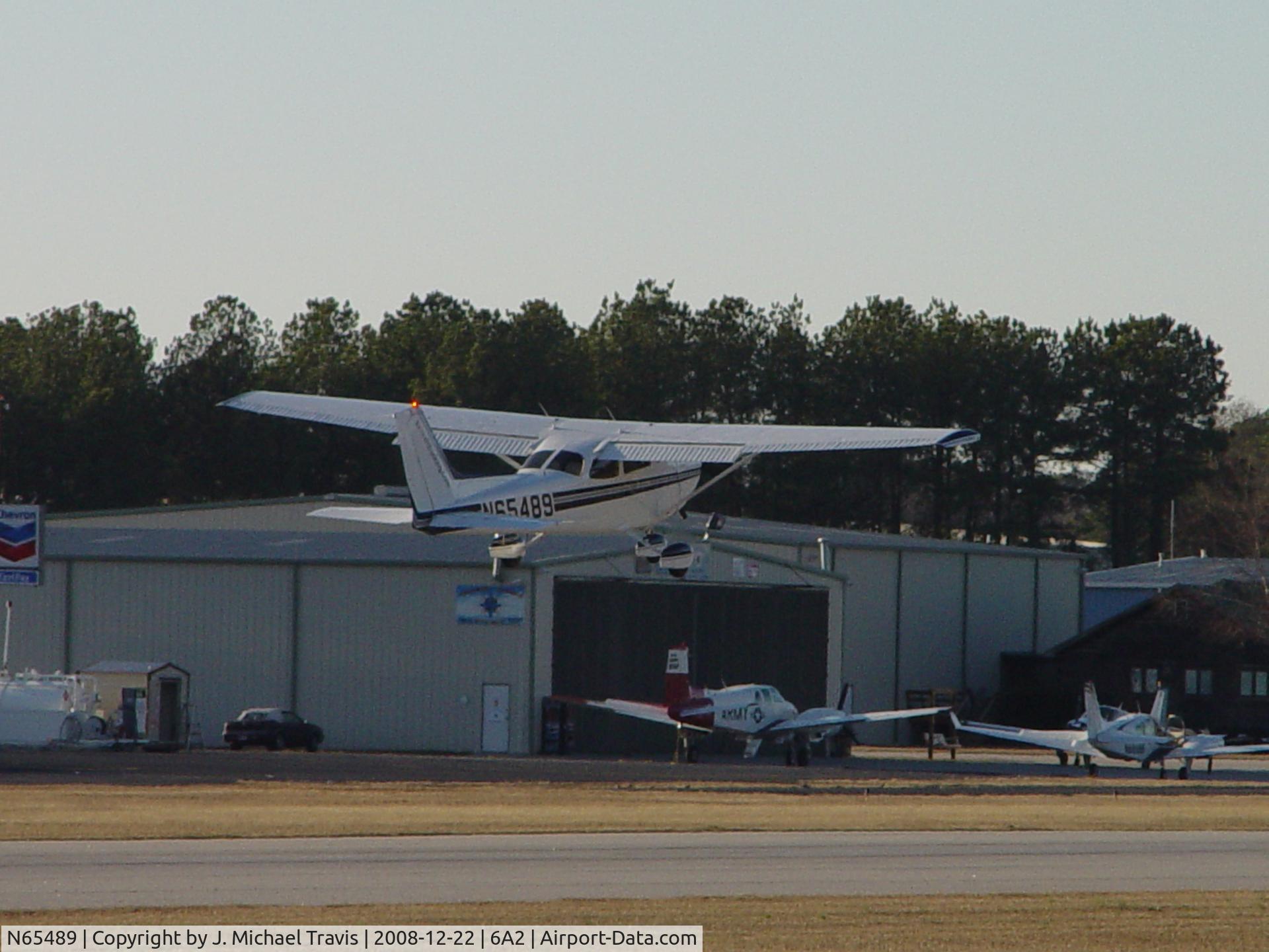 N65489, 1982 Cessna 172P C/N 17275762, N65489 departing RWY32 at 6A2 after a quick turn on 100LL.  I got the beacon in the shot..