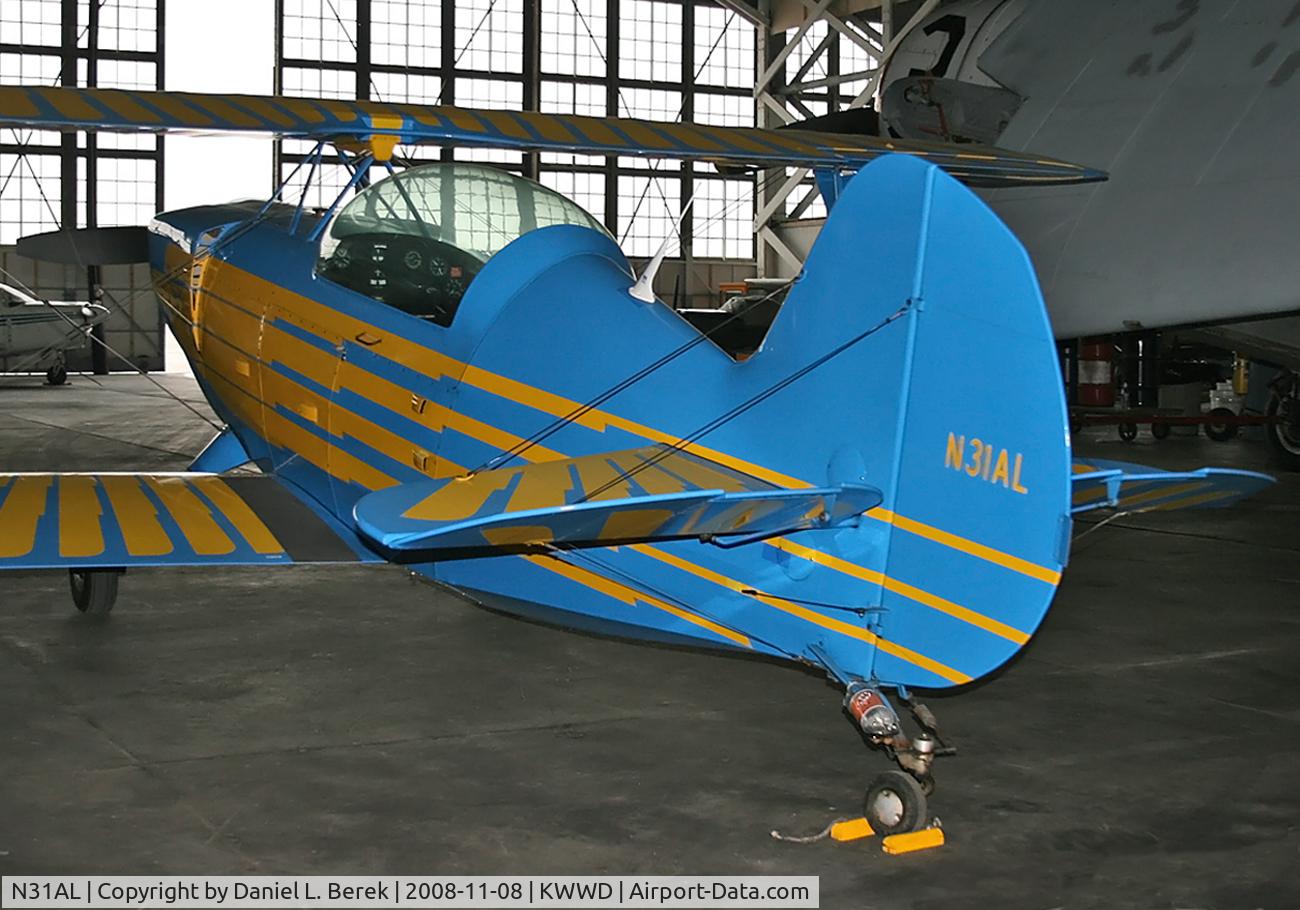 N31AL, 1987 Christen Eagle II C/N LANGENHEIM0001, The bright plumage of this bird manages to shine even in a dark hangar on a rainy autumn day.