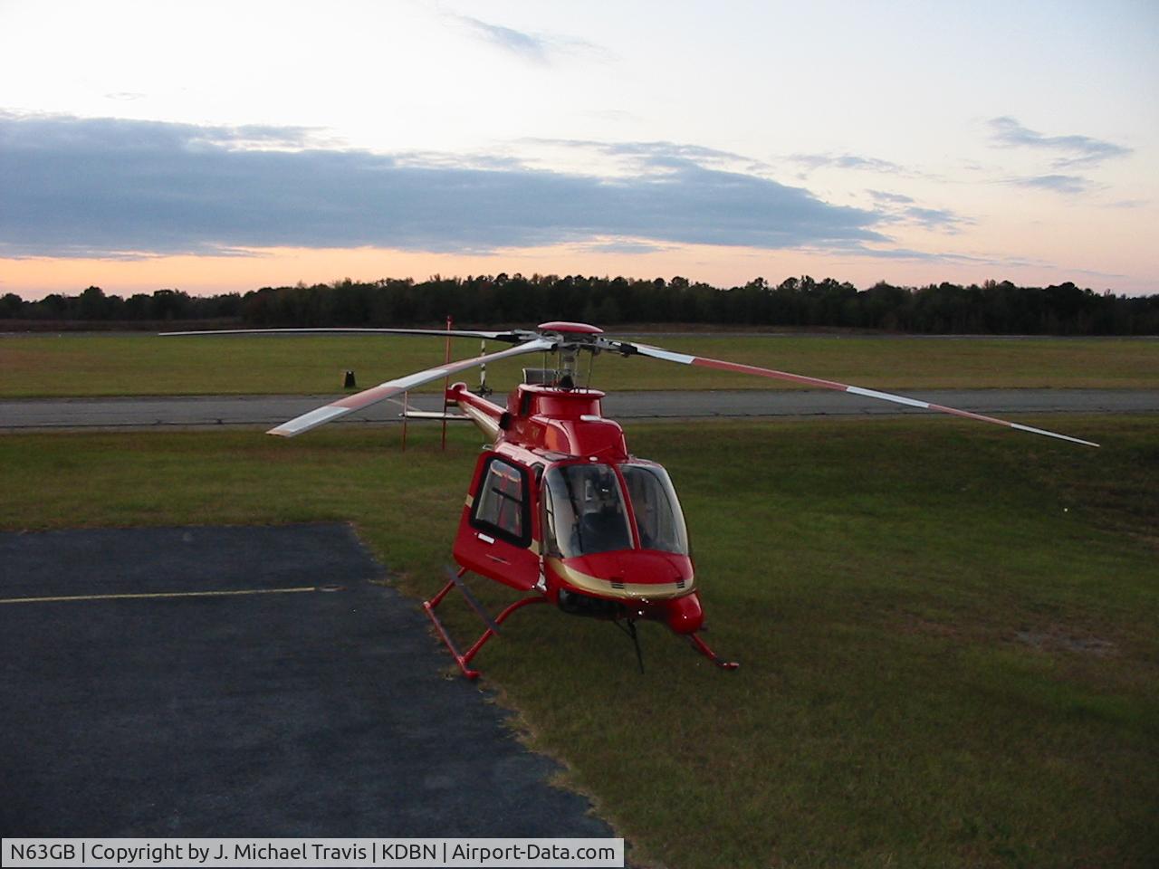 N63GB, 1999 Bell 407 C/N 53333, Bell 407 N63GB on grass next to fuel farm at KDBN.