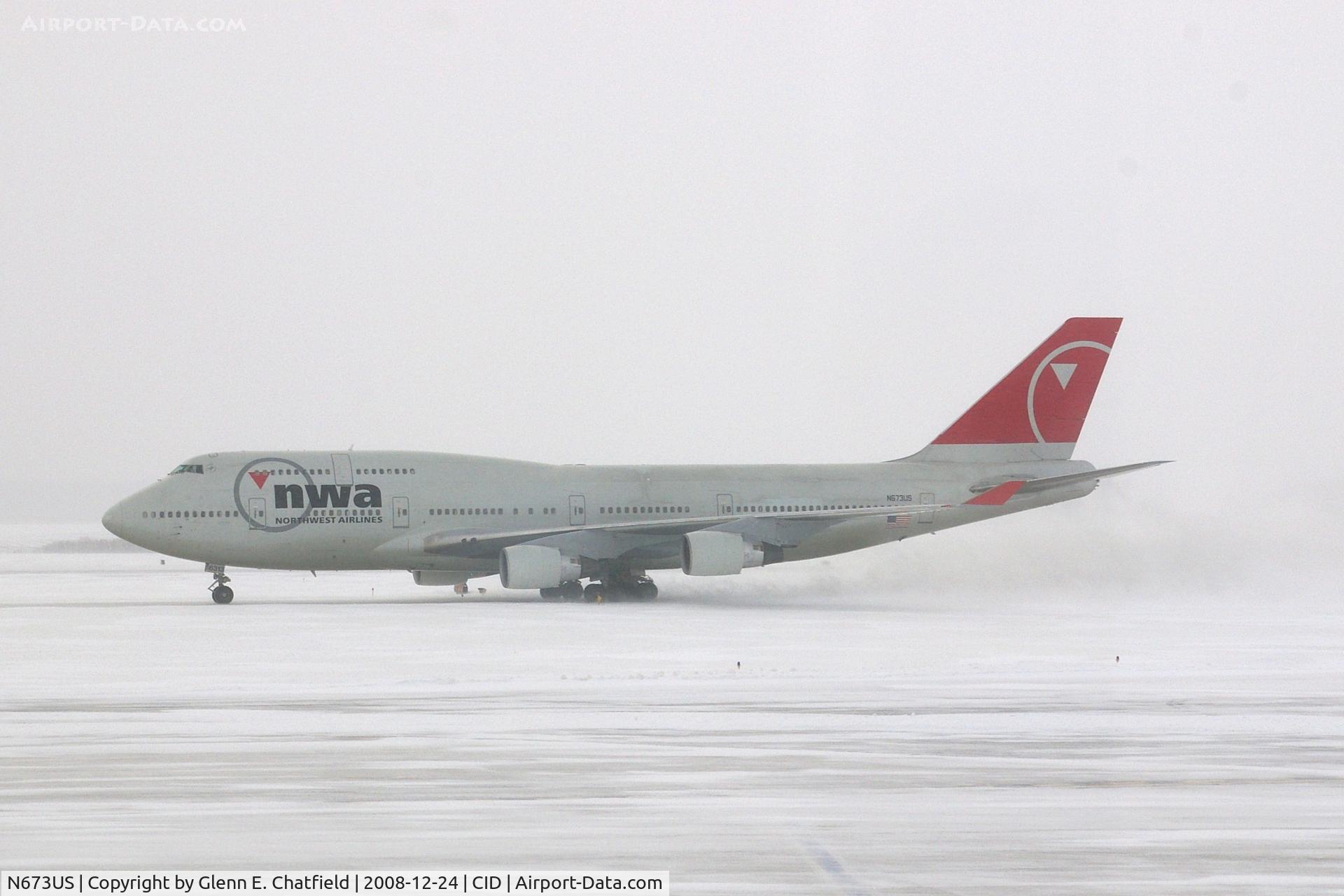 N673US, 1999 Boeing 747-451 C/N 30268, NWA9840  taxiing eastbound on Alpha to pick up the U of I football team.  Snowing with 25-30kt wind blowing snow.