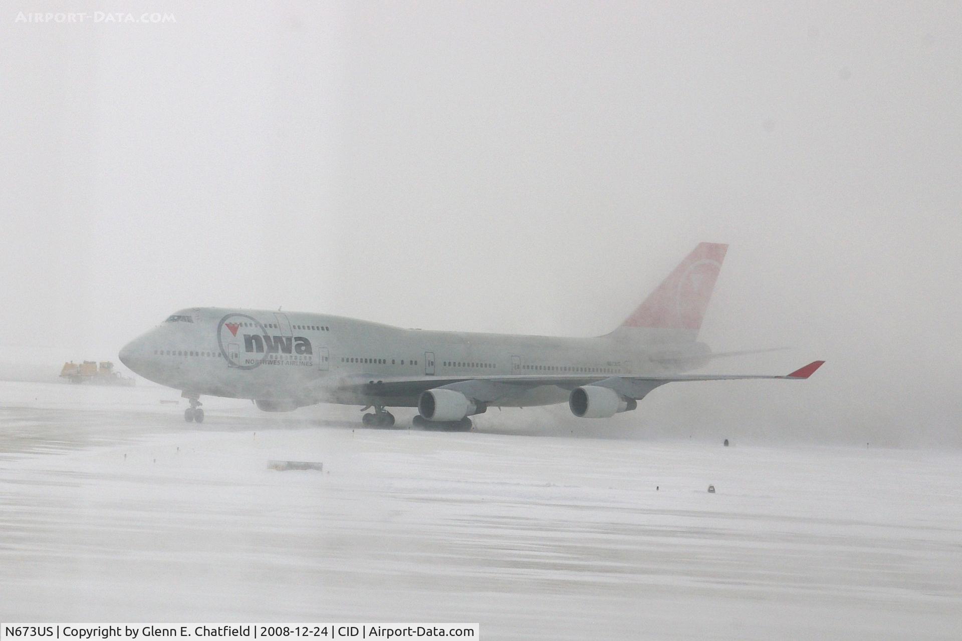 N673US, 1999 Boeing 747-451 C/N 30268, NWA9840  taxiing on to Alpha 4 for parking. Snowing with 25-30kt wind blowing snow.