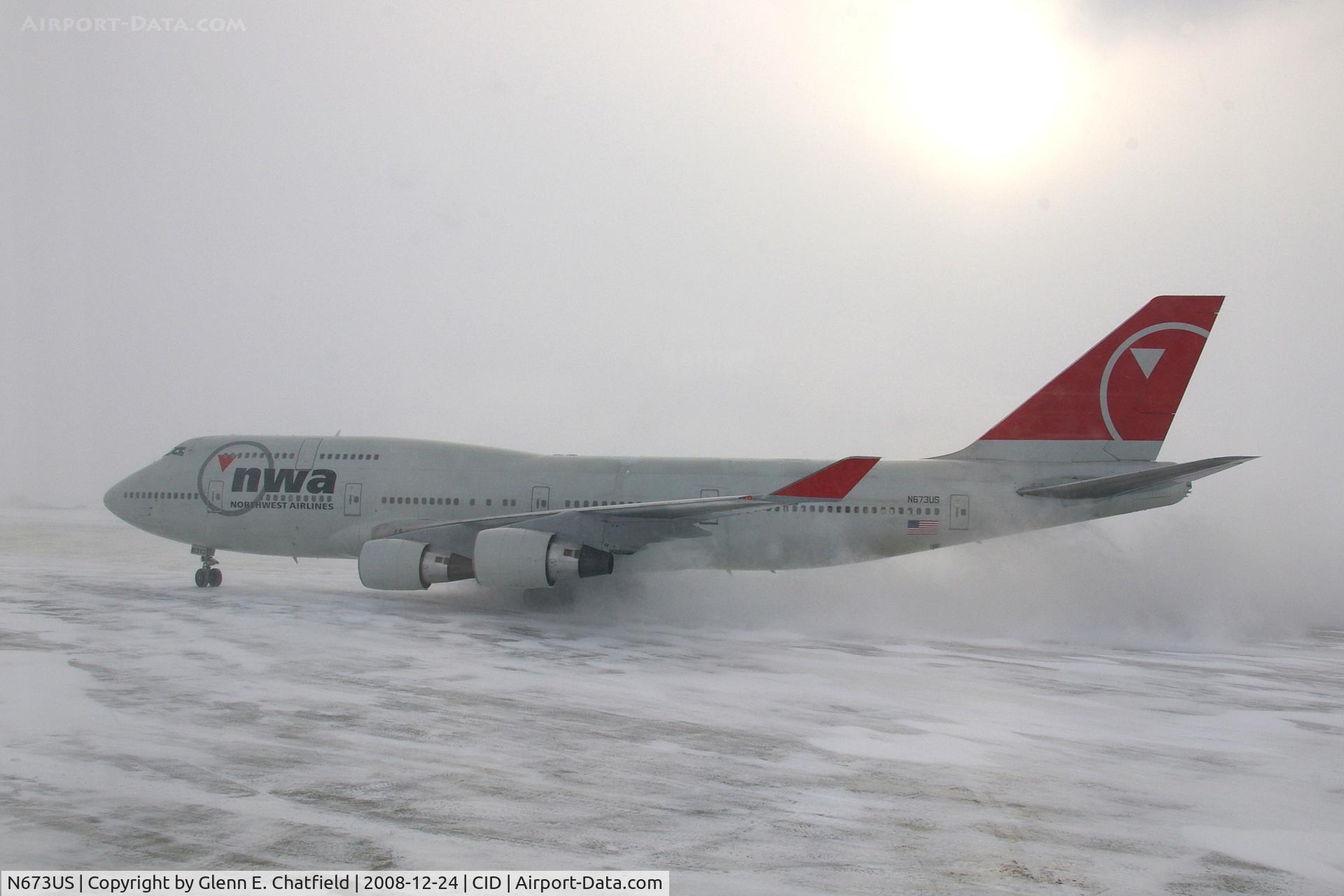 N673US, 1999 Boeing 747-451 C/N 30268, NWA9840  taxiing to the cargo ramp.  Seen from my 2nd floor office window, shooting into the sun - wide angle