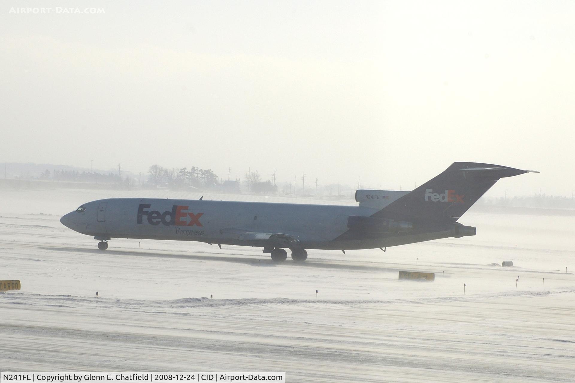 N241FE, 1975 Boeing 727-277 C/N 20979, Taxiing on Alpha to runway 27 for departure.  Looking into the sun and snow