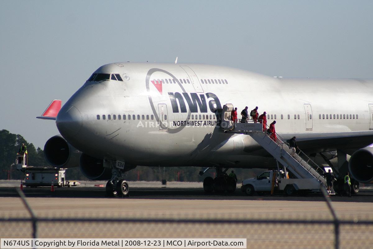 N674US, 1999 Boeing 747-451 C/N 30269, University of Wisconsin Badger football team exiting Northwest 747