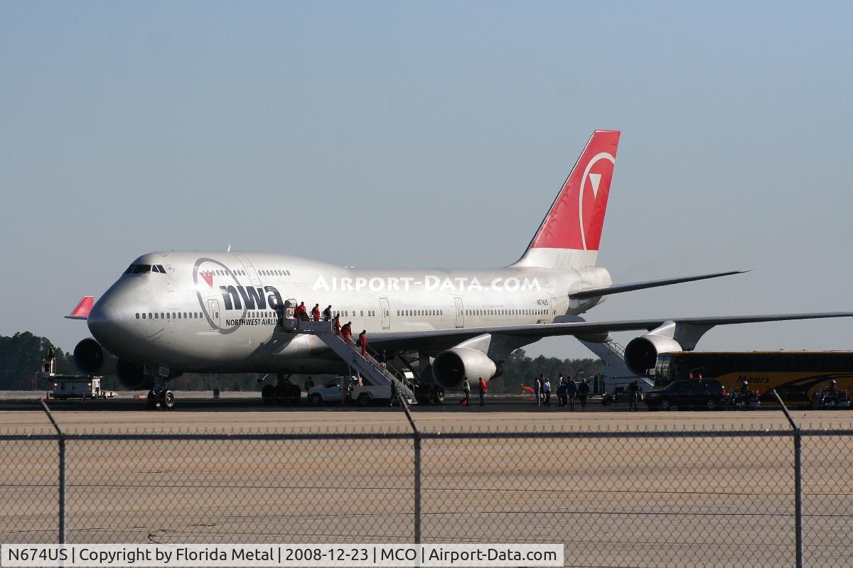 N674US, 1999 Boeing 747-451 C/N 30269, University of Wisconsin Badger football team exiting Northwest 747