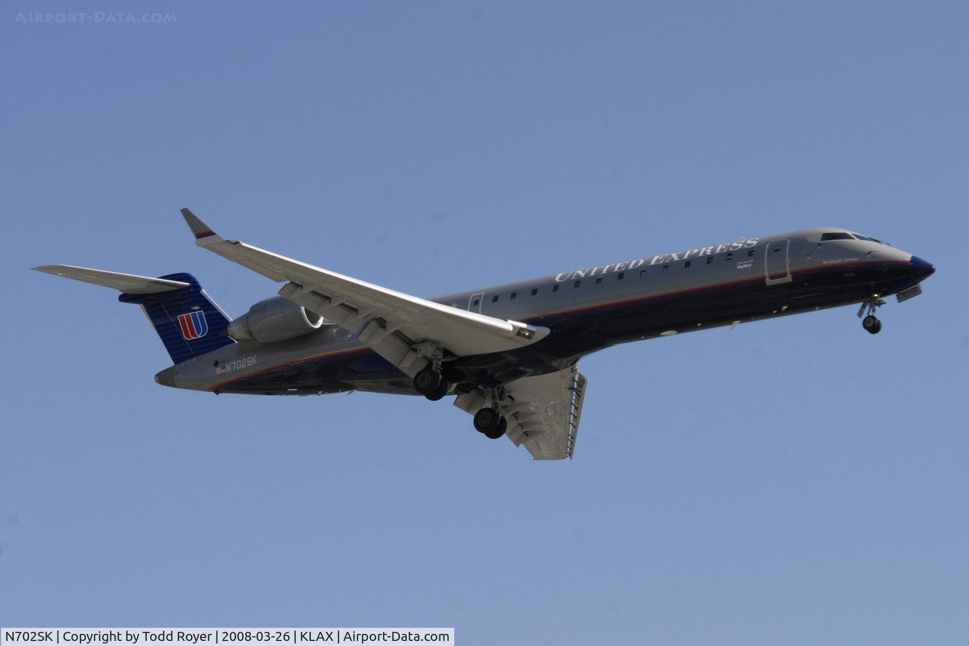 N702SK, 2004 Bombardier CRJ-701ER (CL-600-2C10) Regional Jet C/N 10136, Landing 24R at LAX