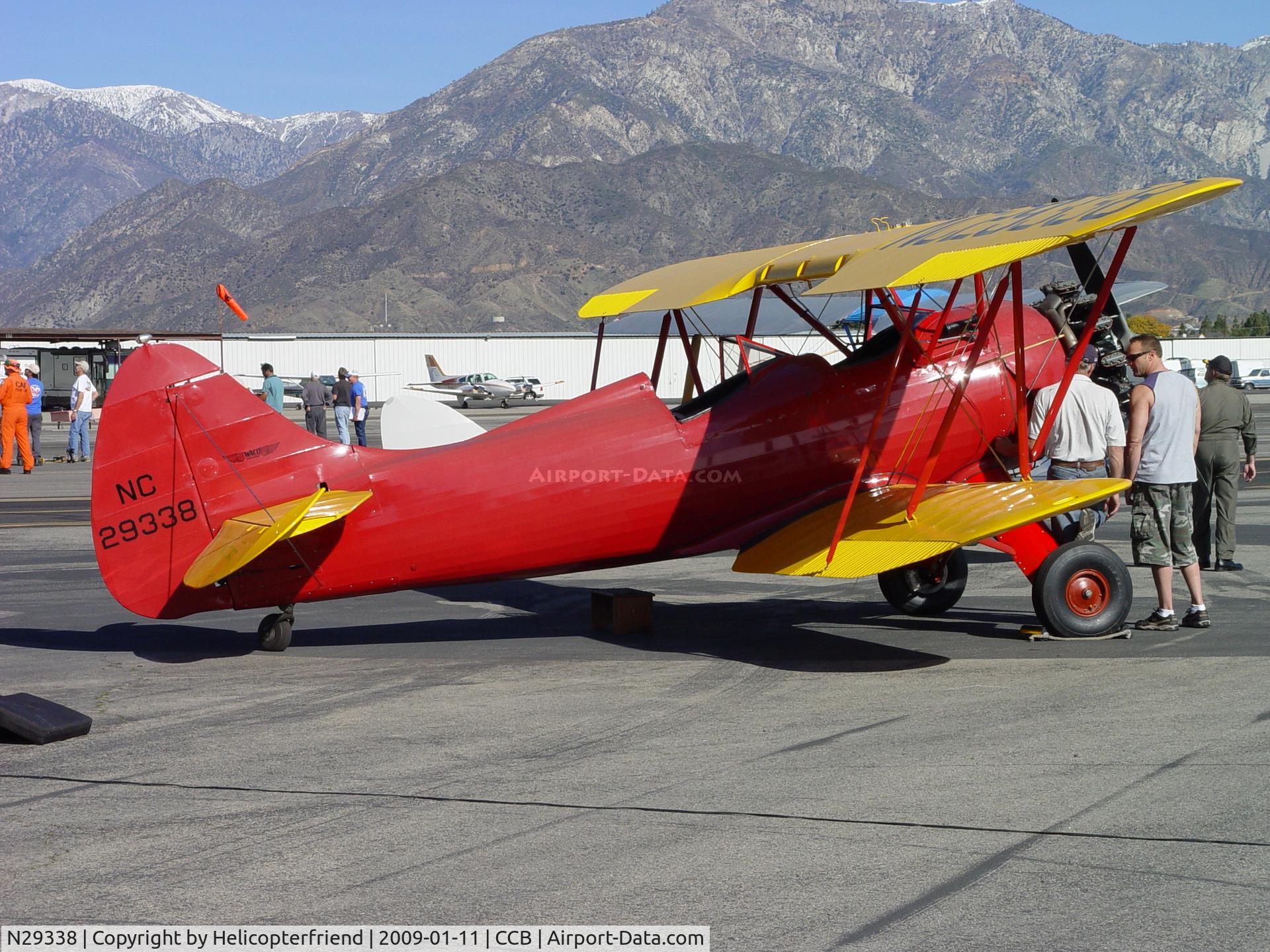 N29338, 1940 Waco UPF-7 C/N 5365, Discussing the engine at Cable Air Show