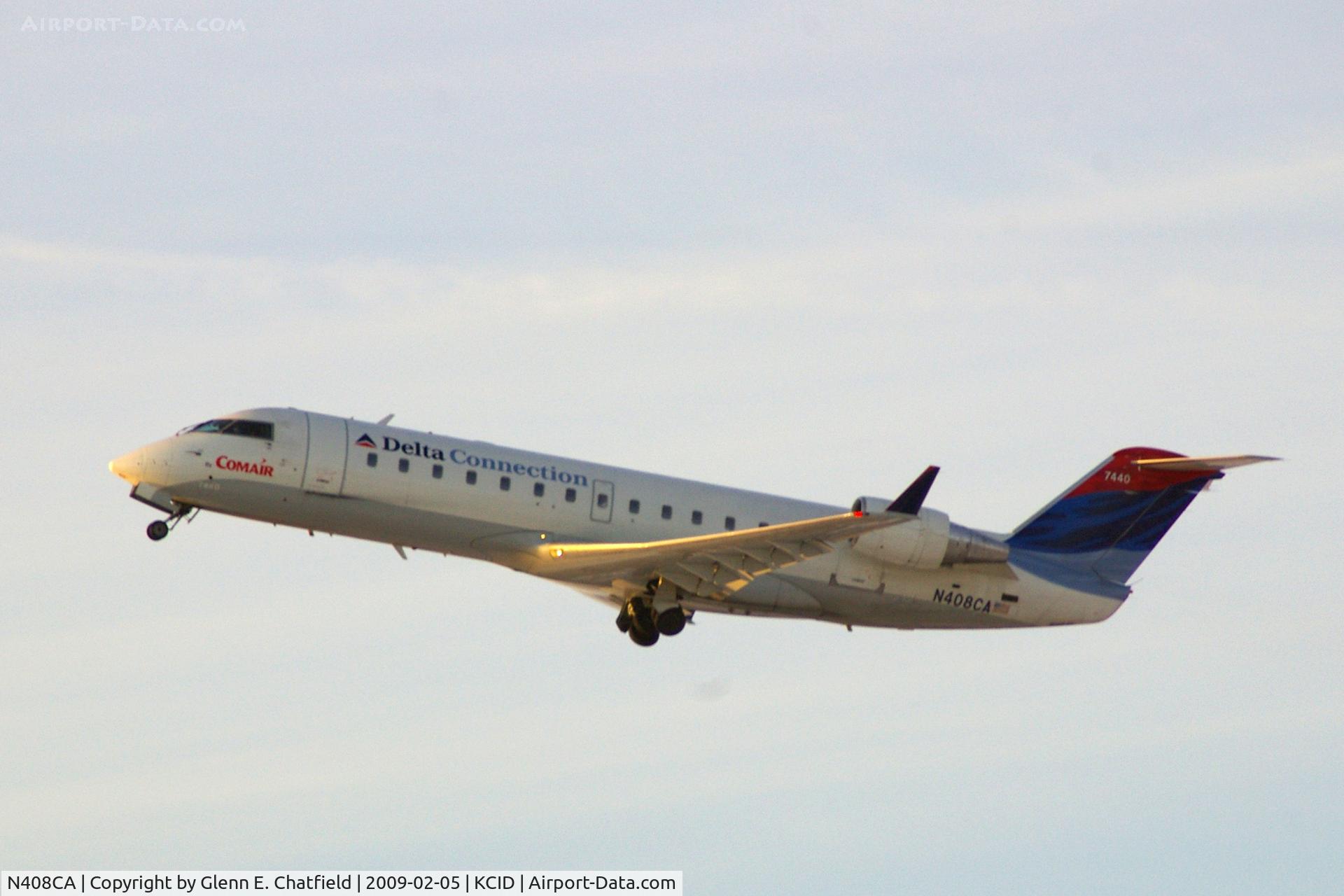 N408CA, 2000 Bombardier CRJ-100ER (CL-600-2B19) C/N 7440, Taking off Runway 9 into the early morning sun.  Seen from my office.