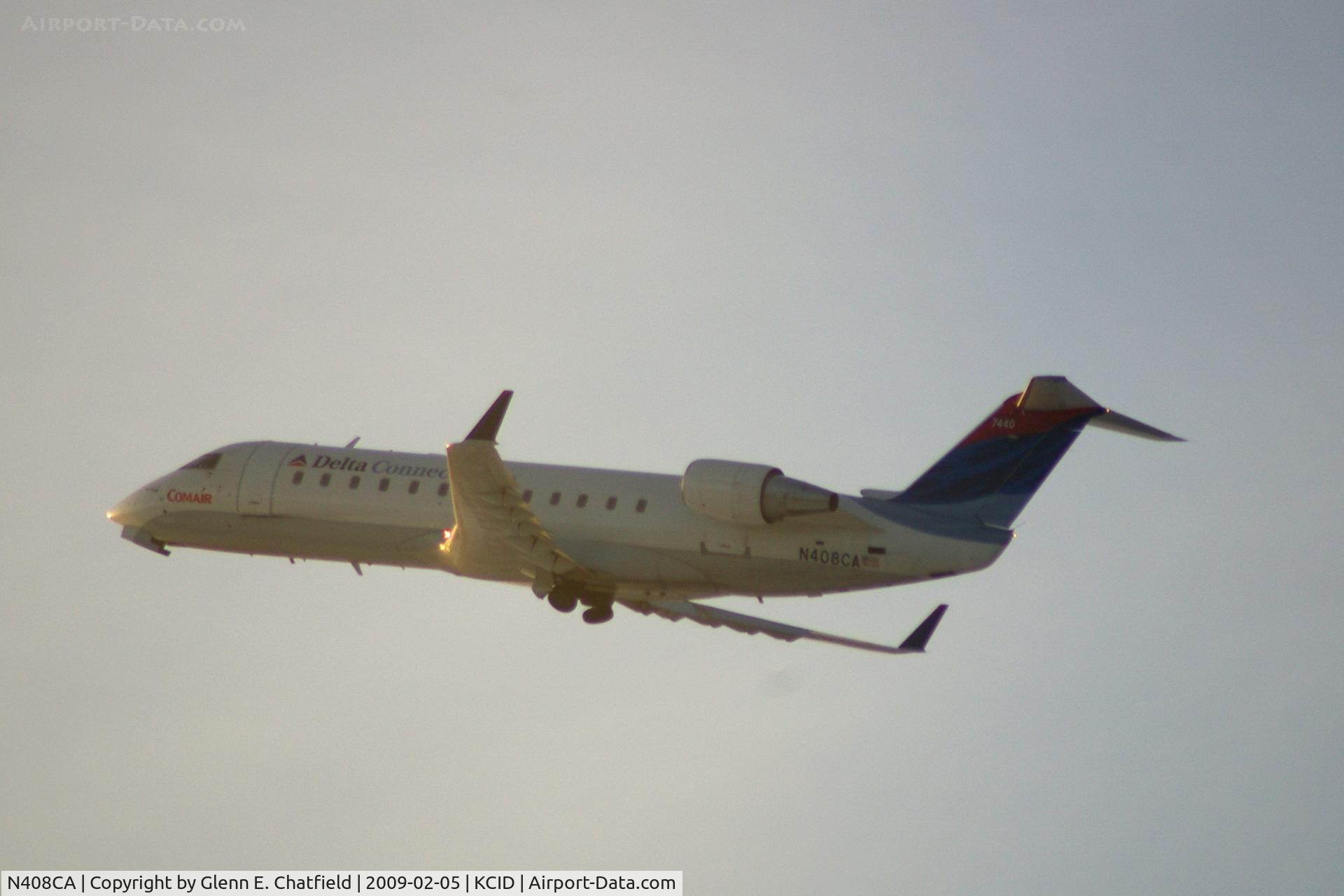 N408CA, 2000 Bombardier CRJ-100ER (CL-600-2B19) C/N 7440, Taking off Runway 9 into the early morning sun.  Seen from my office.