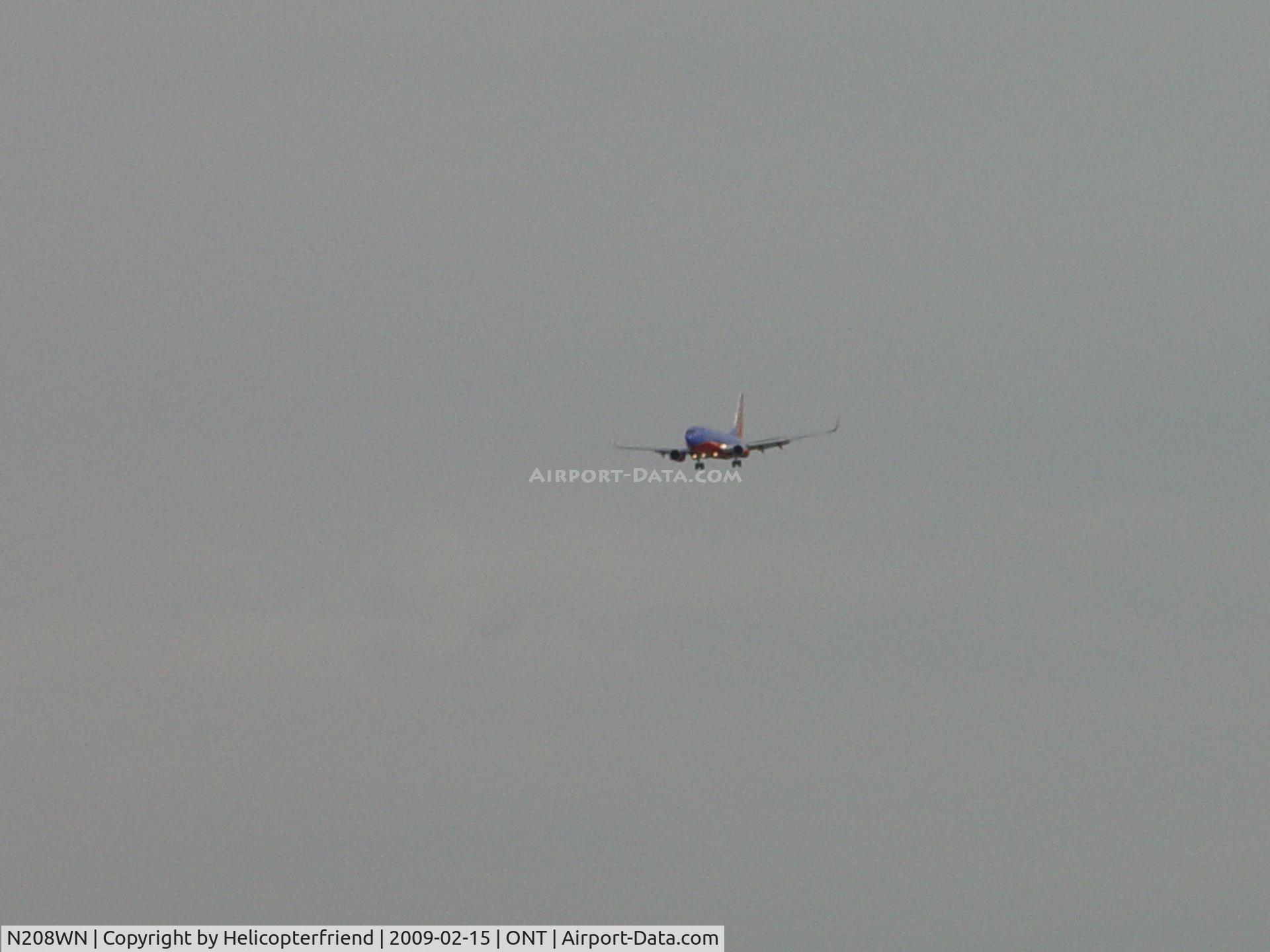 N208WN, 2005 Boeing 737-7H4 C/N 29856, On final to Ontario with 3 lights visible