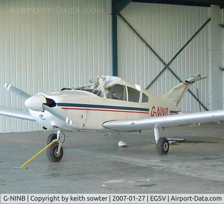 G-NINB, 1973 Piper PA-28-180 Cherokee C/N 28-7305234, In damaged state -  Hangar doors had been sucked in when part of roof blew off in high winds