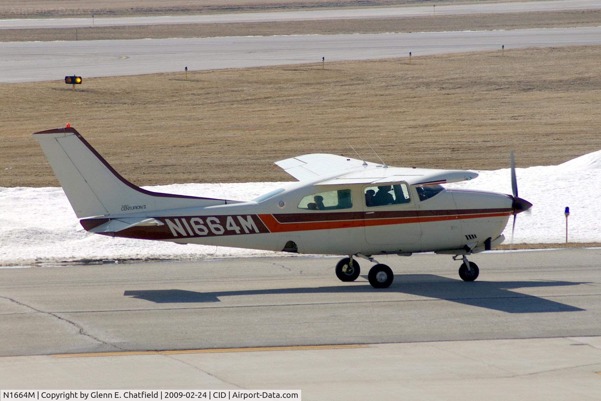 N1664M, 1977 Cessna T210M Turbo Centurion C/N 21061953, Taxiing to Landmark FBO, as seen from my office window.