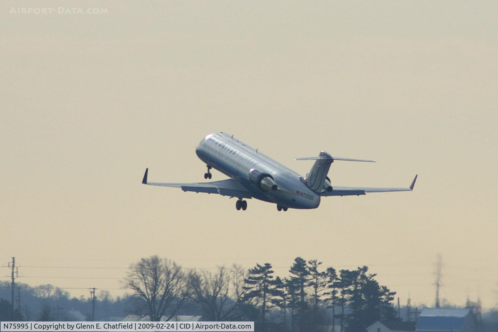 N75995, 1999 Bombardier CRJ-200ER (CL-600-2B19) C/N 7361, Departing runway 13 for ORD, climbing into murky sky