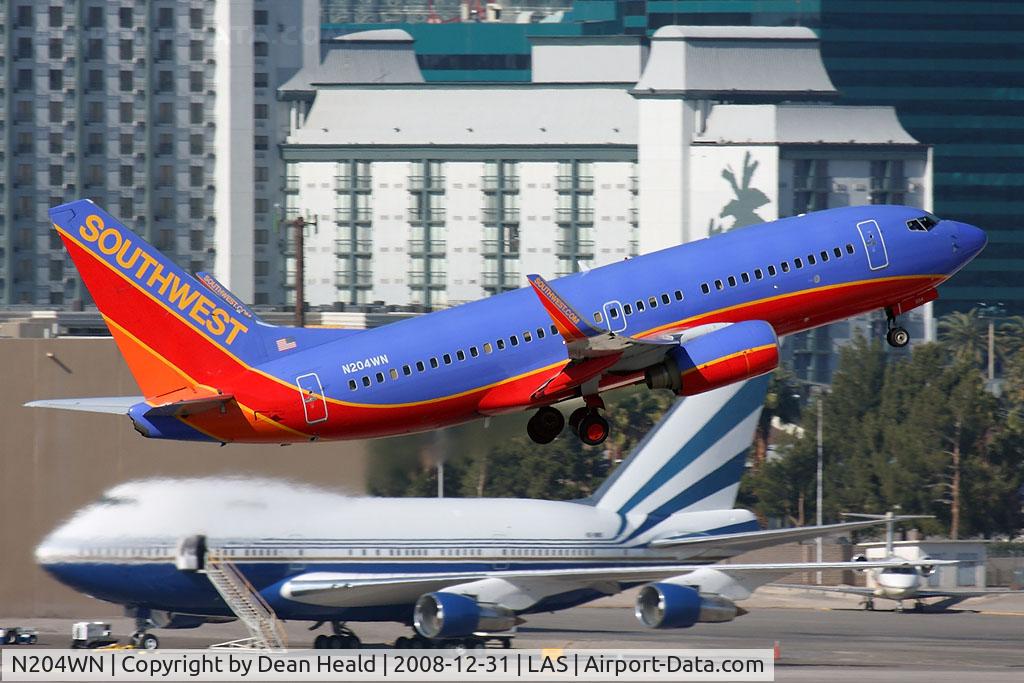 N204WN, 2005 Boeing 737-7H4 C/N 29855, Southwest Airlines N204WN (FLT SWA3439) departing RWY 1R enroute to Los Angeles Int'l (KLAX), with a Venetian 747SP (VQ-BMS) in the background.