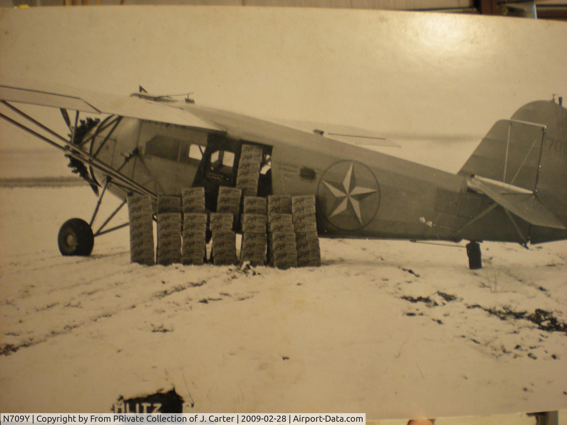N709Y, 1931 American Airplane & Engine Pilgrim 100B C/N 6605, in Alaska Star Colors. Being Loaded with LOTS of Schlitz Beer!