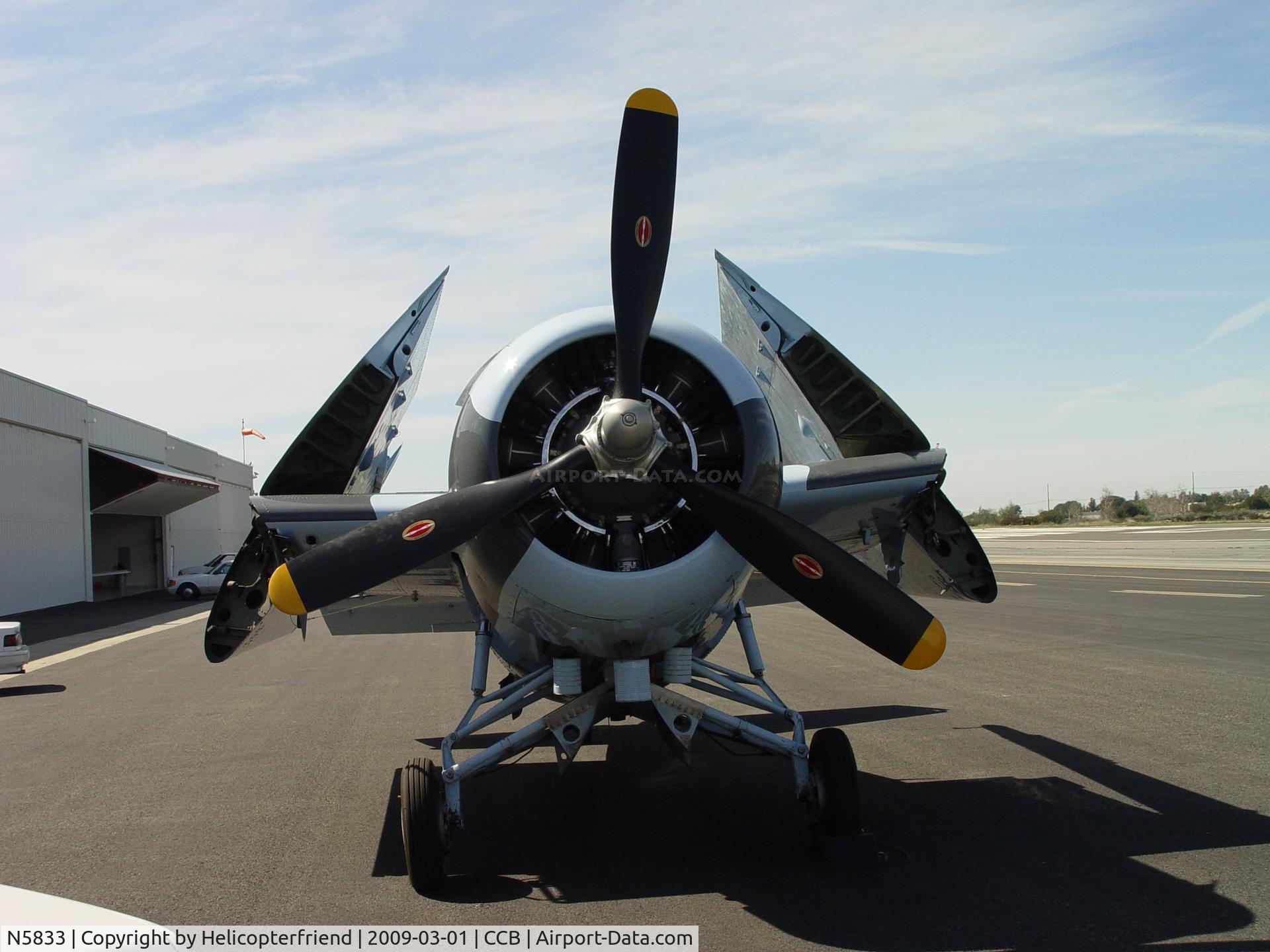 N5833, 1945 General Motors (Grumman) FM-2 Wildcat C/N 5833, Parked with folded wings while hanger being cleaned