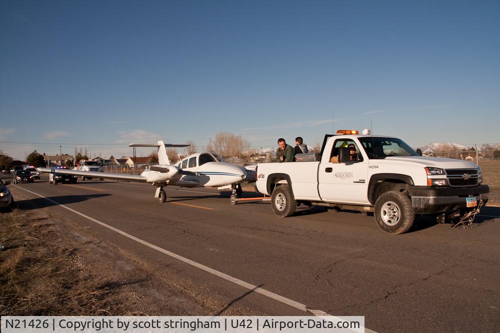 N21426, 1978 Piper PA-44-180 Seminole C/N 44-7995049, being towed back to the airport after landing short, in a field.