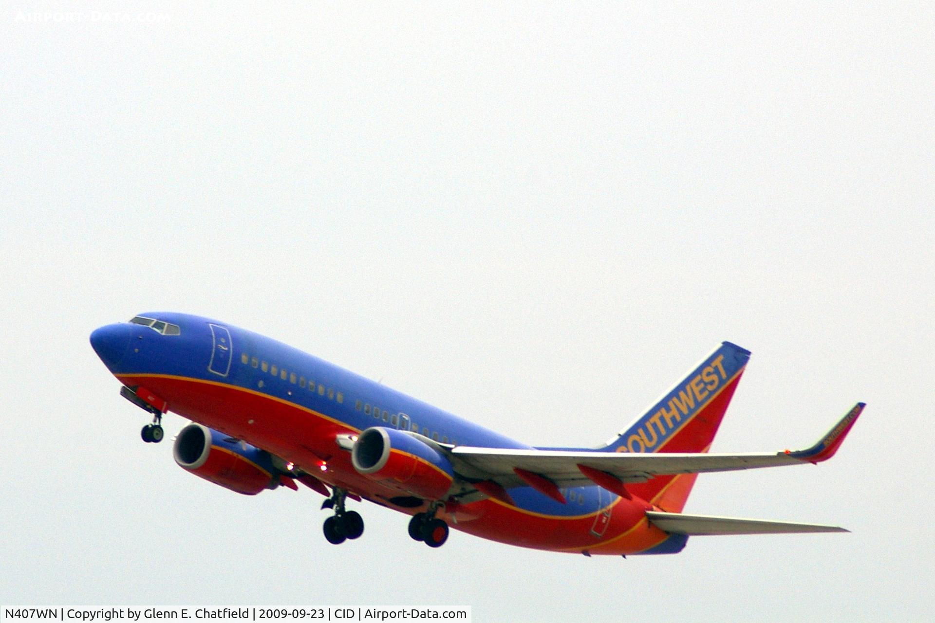 N407WN, 2001 Boeing 737-7H4 C/N 29817, Departing runway 9.  Almost missed this shot, having to bend over equipment to look out the window!
