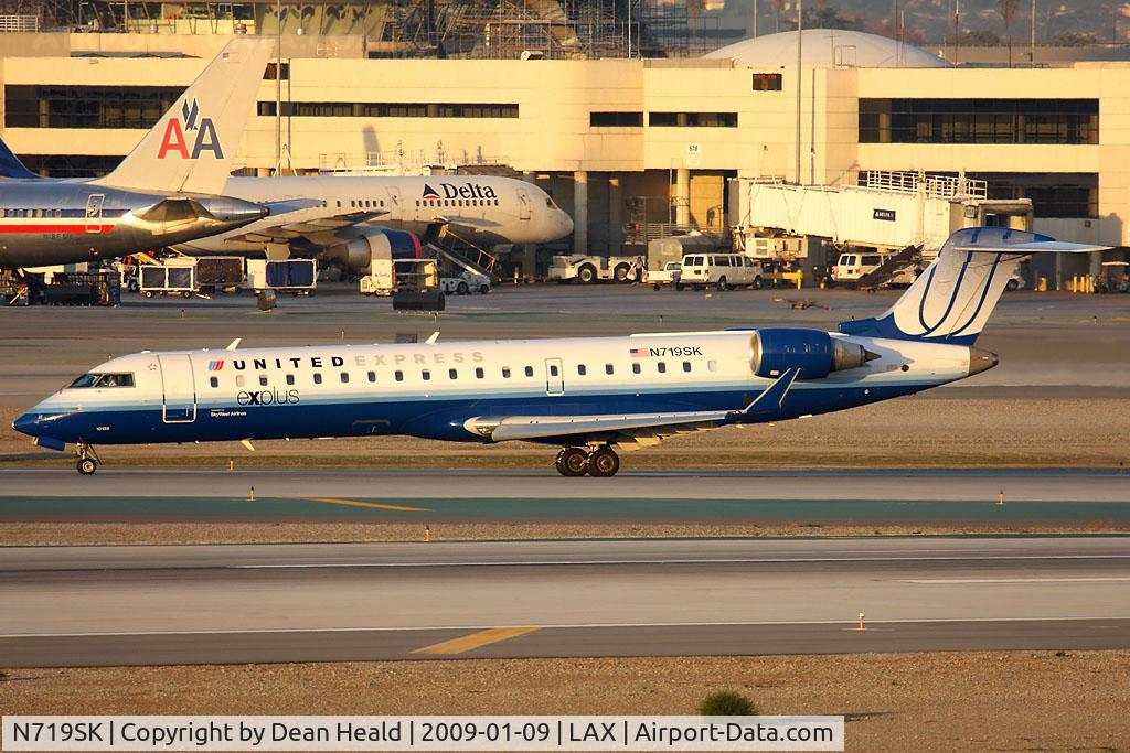 N719SK, 2004 Bombardier CRJ-701ER (CL-600-2C10) Regional Jet C/N 10188, United Express (SkyWest Airlines) N719SK (FLT SKW6082) exitting RWY 25L after arrival from Portland Int'l (KPDX).