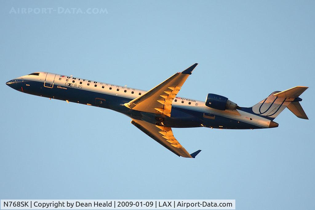 N768SK, 2005 Bombardier CRJ-701ER (CL-600-2C10) Regional Jet C/N 10234, United Express (SkyWest Airlines) N768SK (FLT SKW6071) climbing out from RWY 25R enroute to Portland Int'l (KPDX) late in the day.
