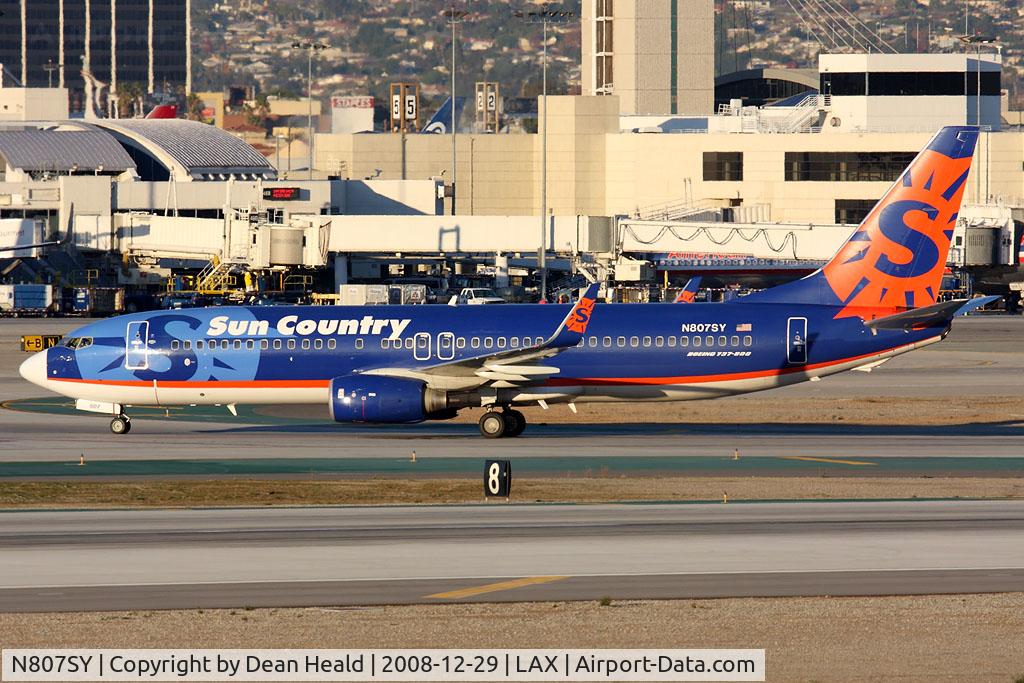 N807SY, 2004 Boeing 737-8BK C/N 33016, Sun Country Airlines N807SY (FLT SCX219) from Laughlin/Bullhead City (KIFP) holding short of RWY 25R after arrival on RWY 25L.