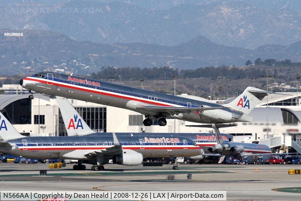 N566AA, 1987 McDonnell Douglas MD-83 (DC-9-83) C/N 49348, American Airlines N566AA (FLT AAL1372) departing RWY 25R enroute to Chicago O'Hare Int'l (KORD) with a bunch of company aircraft in the background.