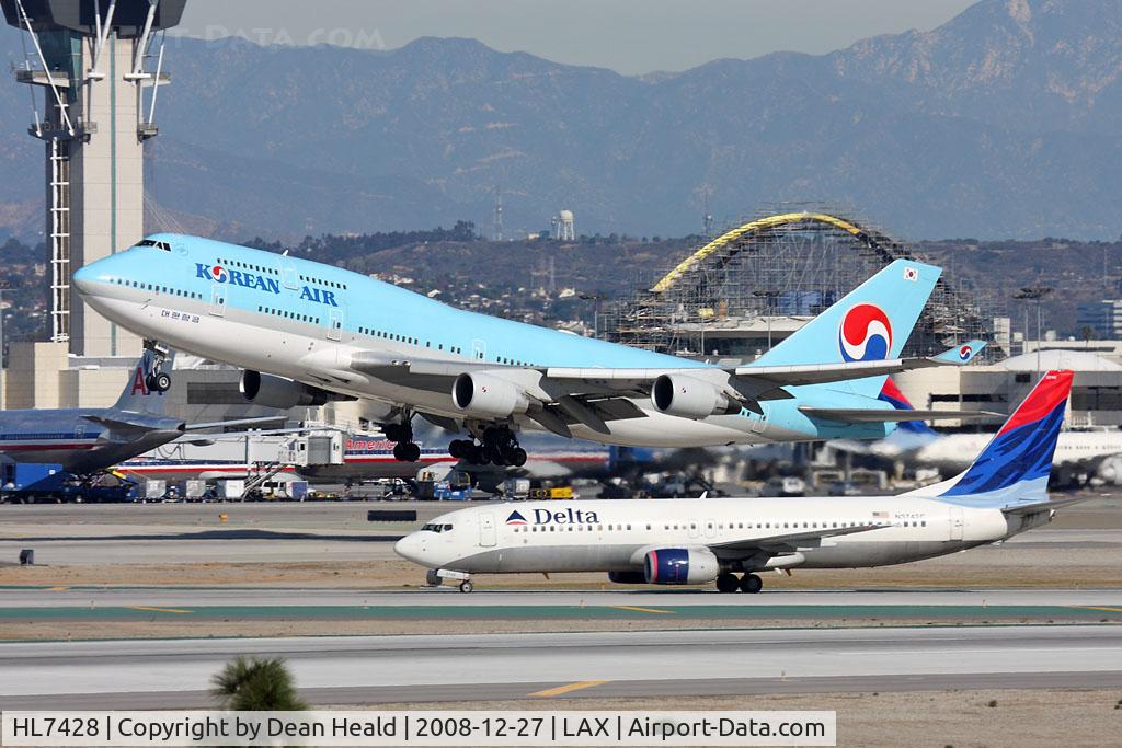 HL7428, 1998 Boeing 747-48E C/N 28552, Korean Air HL7498 (FLT KAL18) departing RWY 25R enroute to Seoul Incheon Int'l (RKSI) while Delta Air Lines N3742C (FLT DAL1121) holds short of RWY 25R after arrival from Cincinatti Northern Kentucky (KCVG) on RWY 25L.