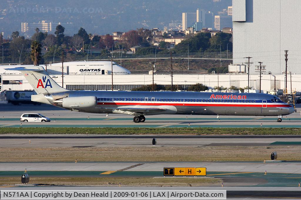 N571AA, 1987 McDonnell Douglas MD-83 (DC-9-83) C/N 49353, American Airlines N571AA (FLT AAL2450) from San Francisco Int'l (KSFO) taxiing to the gate with a company vehicle at it's side after arrival on the North Complex.