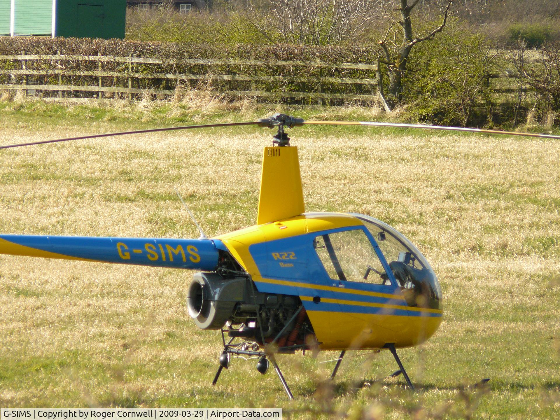 G-SIMS, 1990 Robinson R22 Beta C/N 1596, We were out walking, this flew over and landed in a field near Bracepeth, County Durham, England.