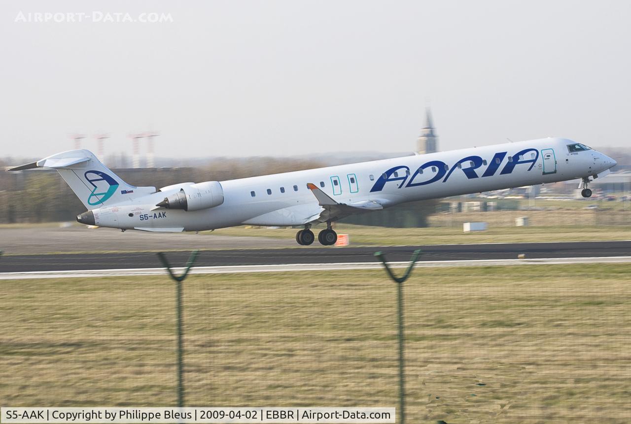 S5-AAK, 2007 Canadair CRJ-900ER (CL-600-2D24) C/N 15128, Lift off from rwy 07R in the late afternoon.