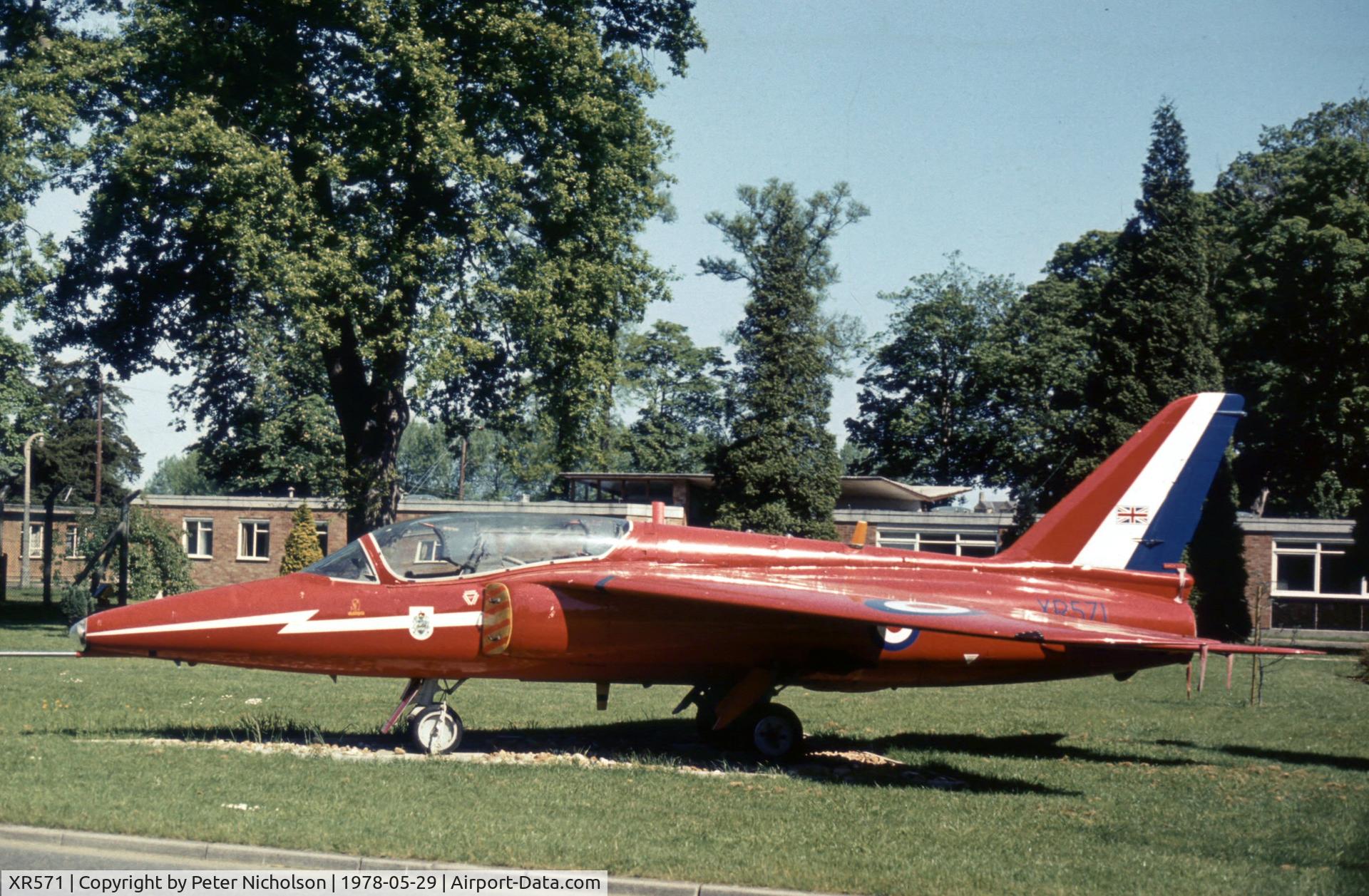 XR571, 1963 Hawker Siddeley Gnat T.1 C/N FL561, Gnat T.1 in Red Arrows colour scheme as gate guardian at RAF Brampton in the Summer of 1978.