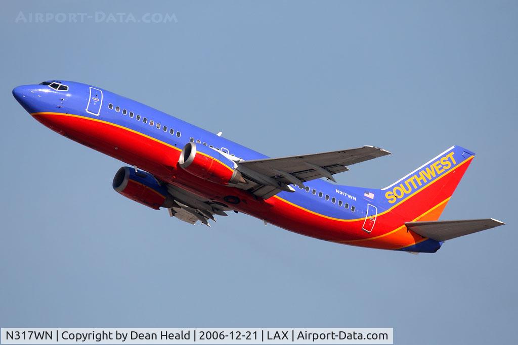 N317WN, 1988 Boeing 737-3Q8 C/N 24068, Southwest Airlines N317WN (FLT SWA1739) climbing out from RWY 25R enroute to William P Hobby Airport (KHOU) - Houston, TX.