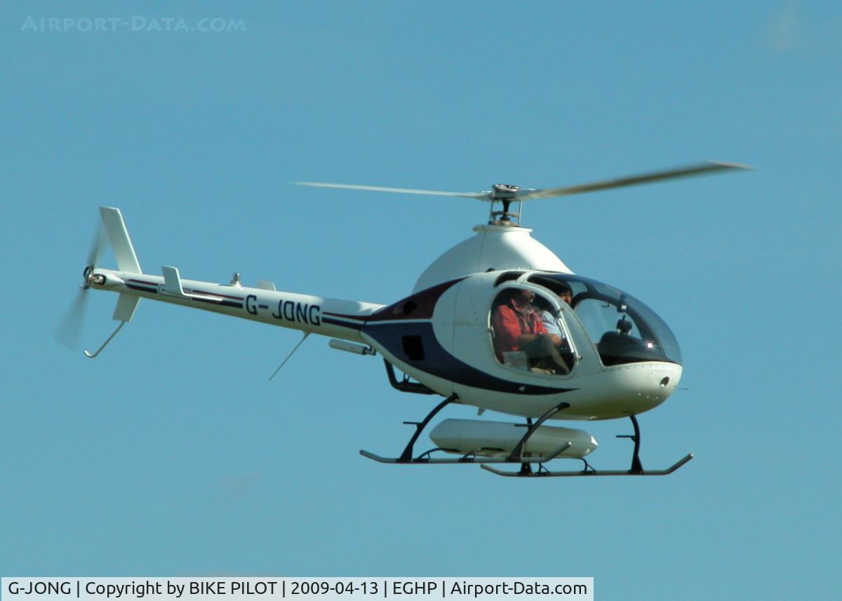 G-JONG, 2004 Rotorway Exec 162F C/N 6168, FLYING PAST THE CLUB HOUSE ON DEPARTURE