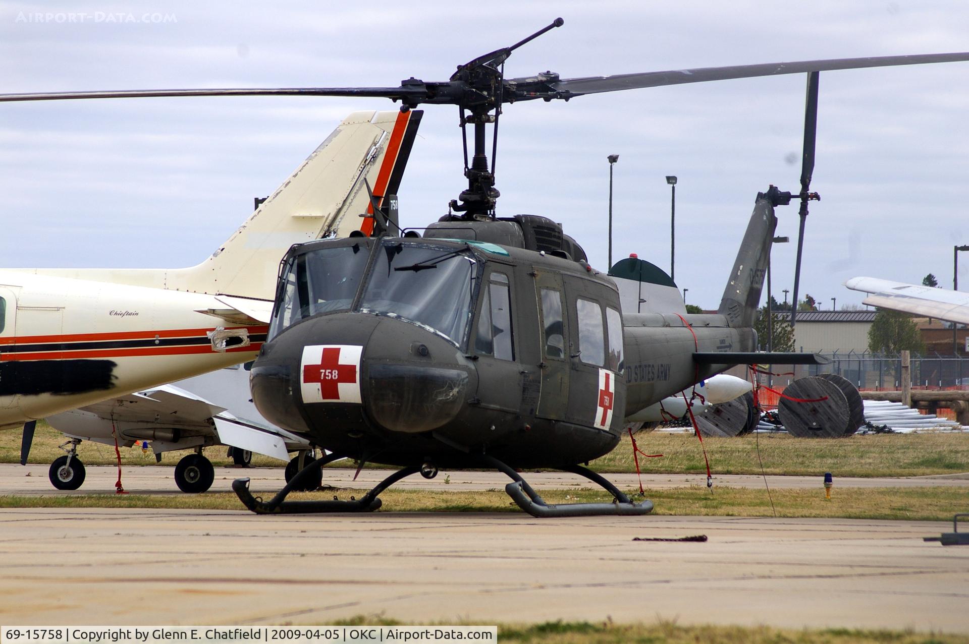 69-15758, 1969 Bell UH-1V Iroquois C/N 12046, At the Metro Tech Aviation Career Campus.  Photo shot through a chain-link fence