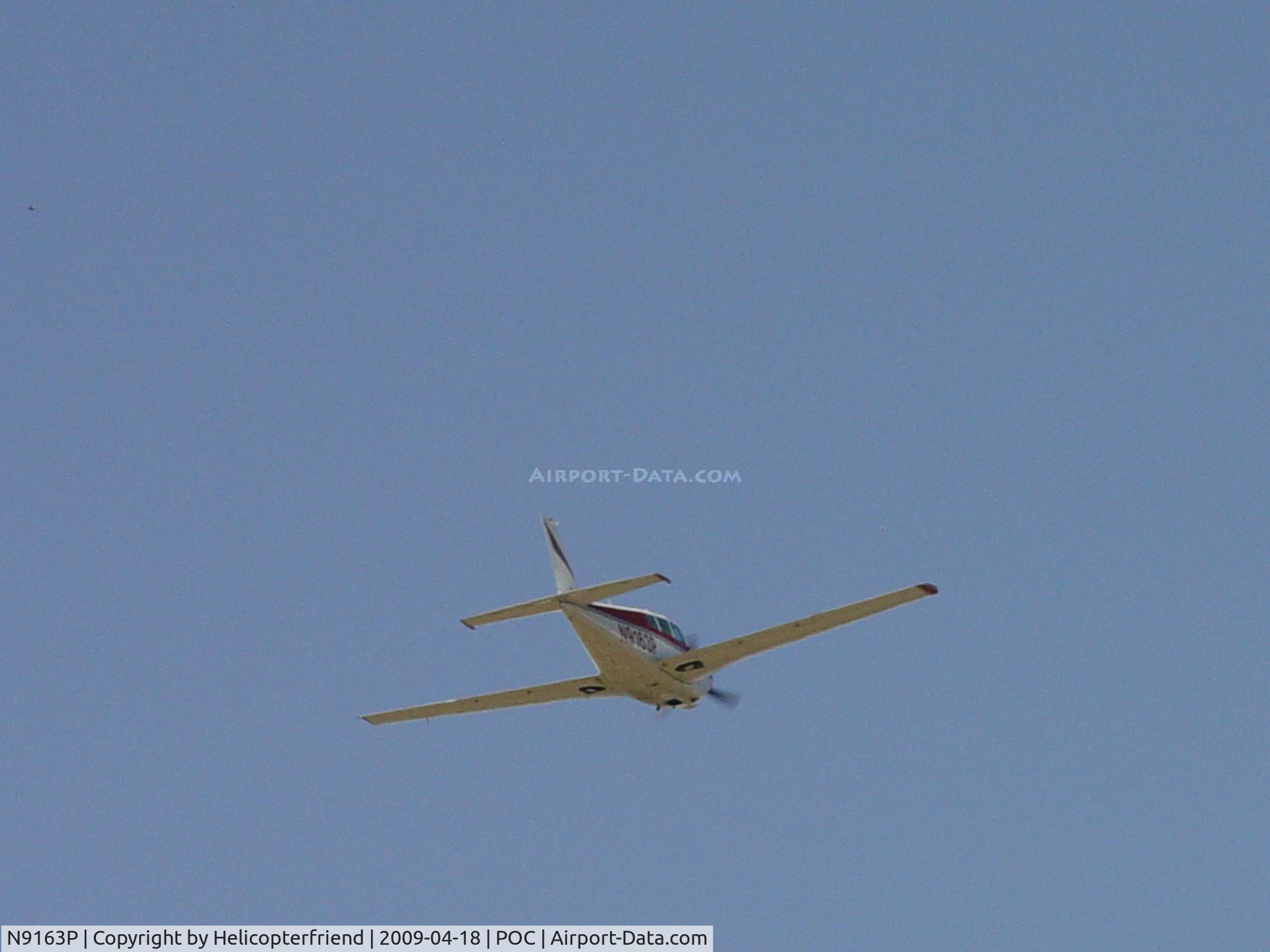 N9163P, 1966 Piper PA-24-260 C/N 24-4651, Wheels retracted and heading out over Puddingstone Lake, westbound
