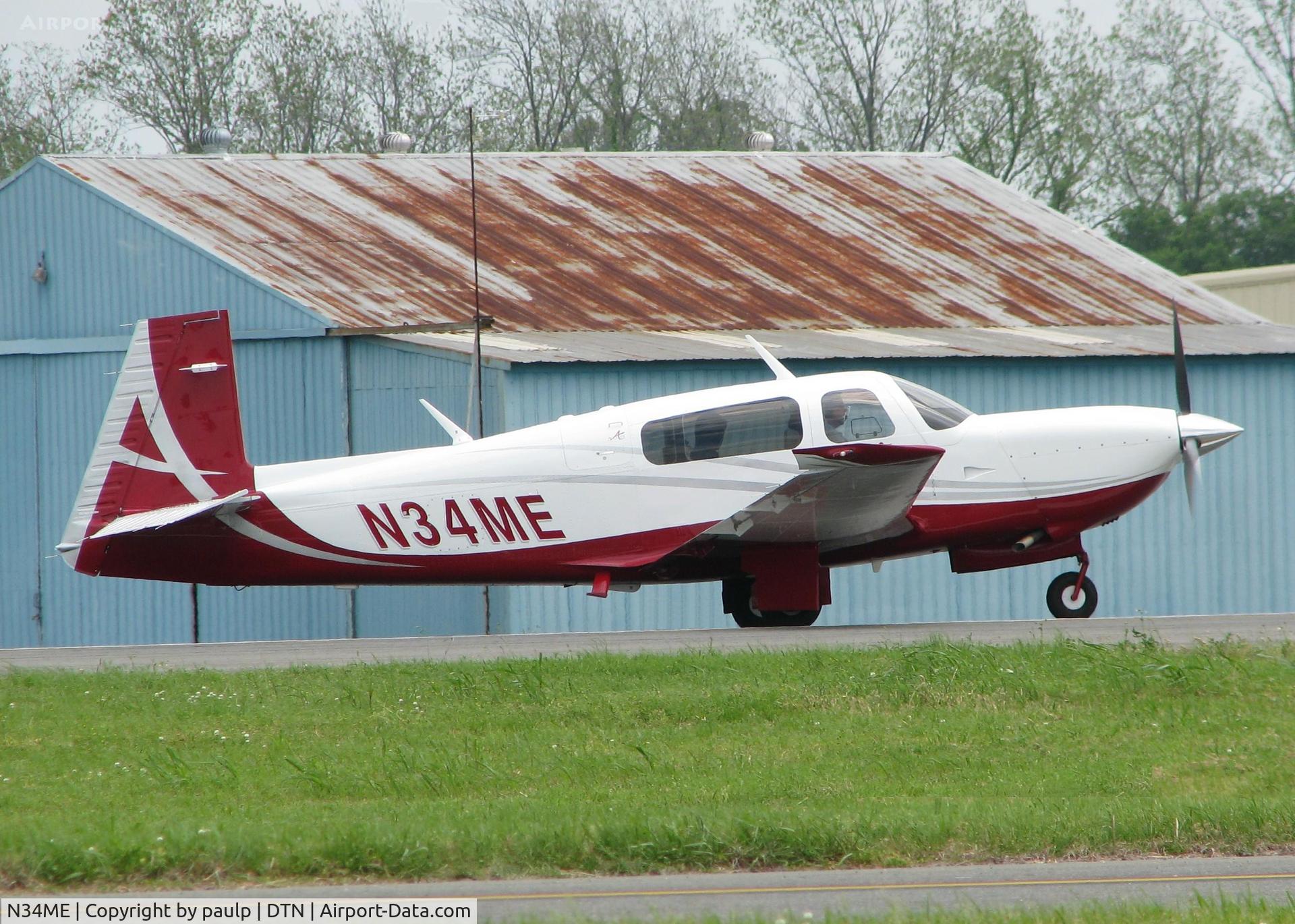 N34ME, Mooney M20TN Acclaim C/N 31-0124, Starting to roll for take off on runway 14 at the Shreveport Downtown airport. Mooney really does make a great looking aircraft. Was N124TN.