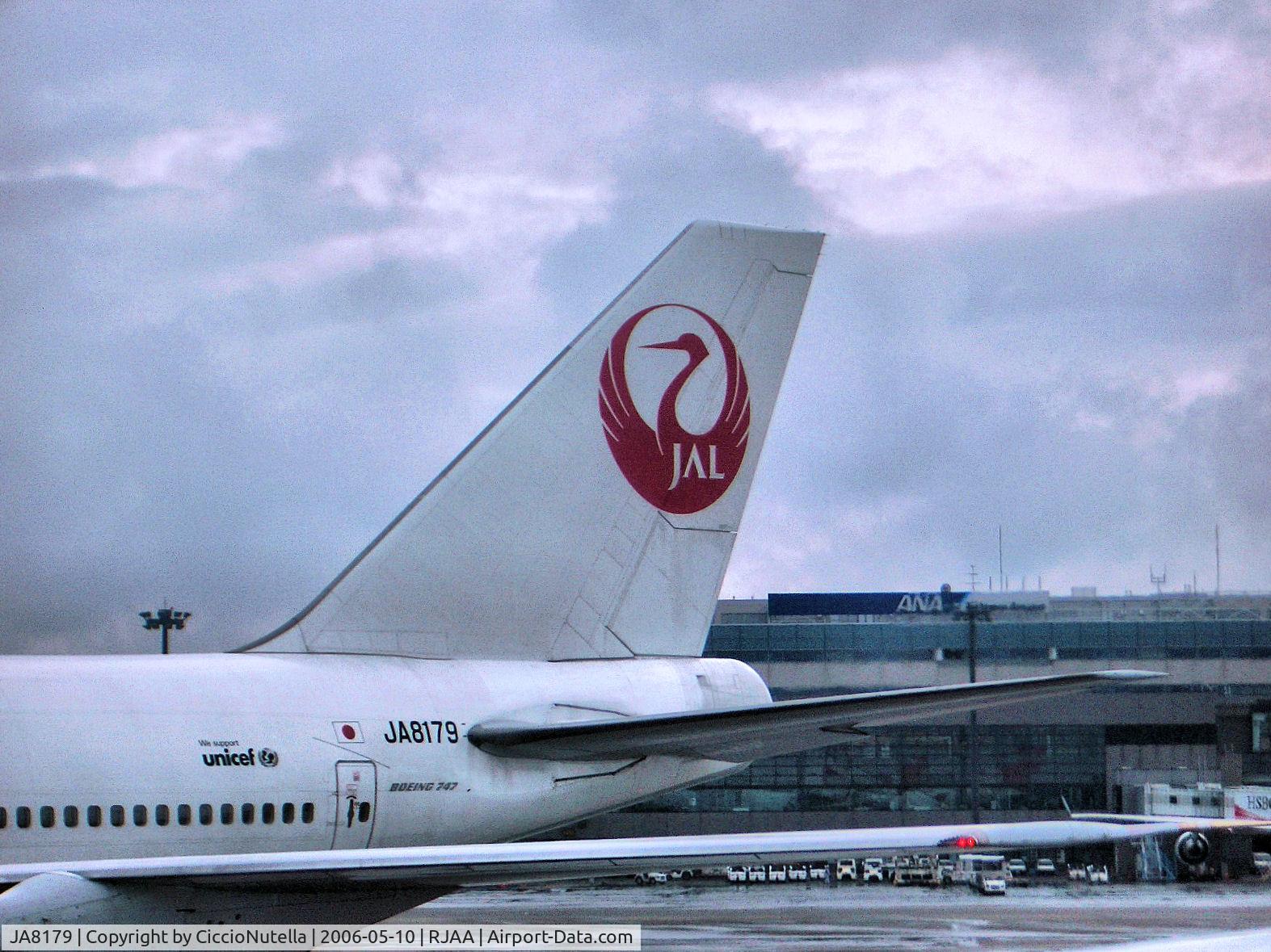JA8179, 1987 Boeing 747-346 C/N 23640, Watching the tail of a JAL Boeing 767 parked at Narita Tokyo Airport