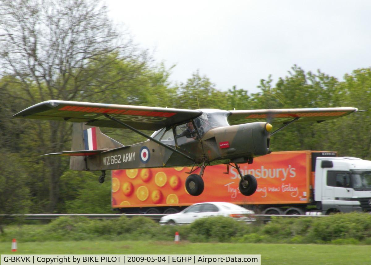 G-BKVK, 1954 Auster AOP.9 C/N AUS/10/2, THERE I WAS TRYING TO PHOTOGRAPH THIS TRUCK AND AN AUSTER FLEW PAST