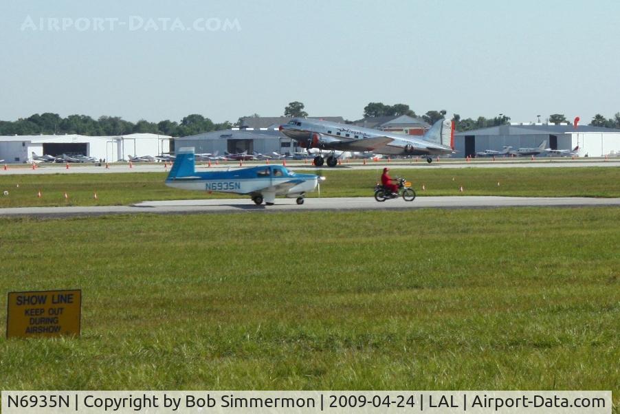 N6935N, 1968 Mooney M20C Ranger C/N 680188, Departing Sun N Fun 2009 - Lakeland, Florida. N17334 in the background
