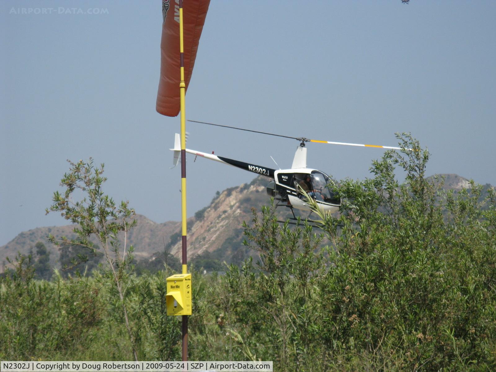 N2302J, 1946 Robinson R22 Beta C/N 1946, 1946 (sic) Robinson R22 BETA, Lycoming O-320, departure past the 04 windsock
