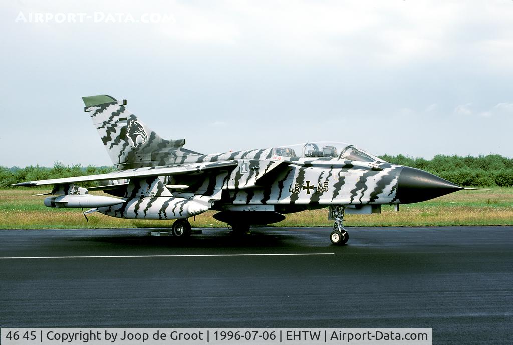46 45, Panavia Tornado ECR C/N 873/GS278/4345, After a heavy thunderstorm the sky finally cleared, making the water on the black asphalt steam... Paint scheme for the 1996 Tiger Meet.