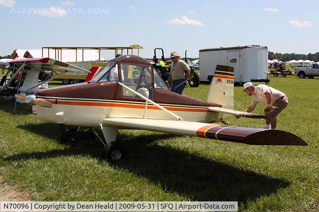 N70096, 1994 Carruthers Steven Super Cat C/N 527, The pilot checks the wires of this 1994 Carruthers Super Cat before flight while a friend looks on. This aircraft looks like a miniature version of an AgCat. Nice!