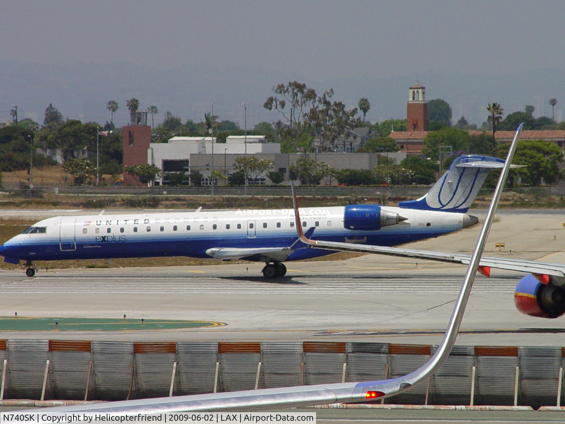 N740SK, 2005 Bombardier CRJ-701 (CL-600-2C10) Regional Jet C/N 10196, United Express rolling westbound on 24L