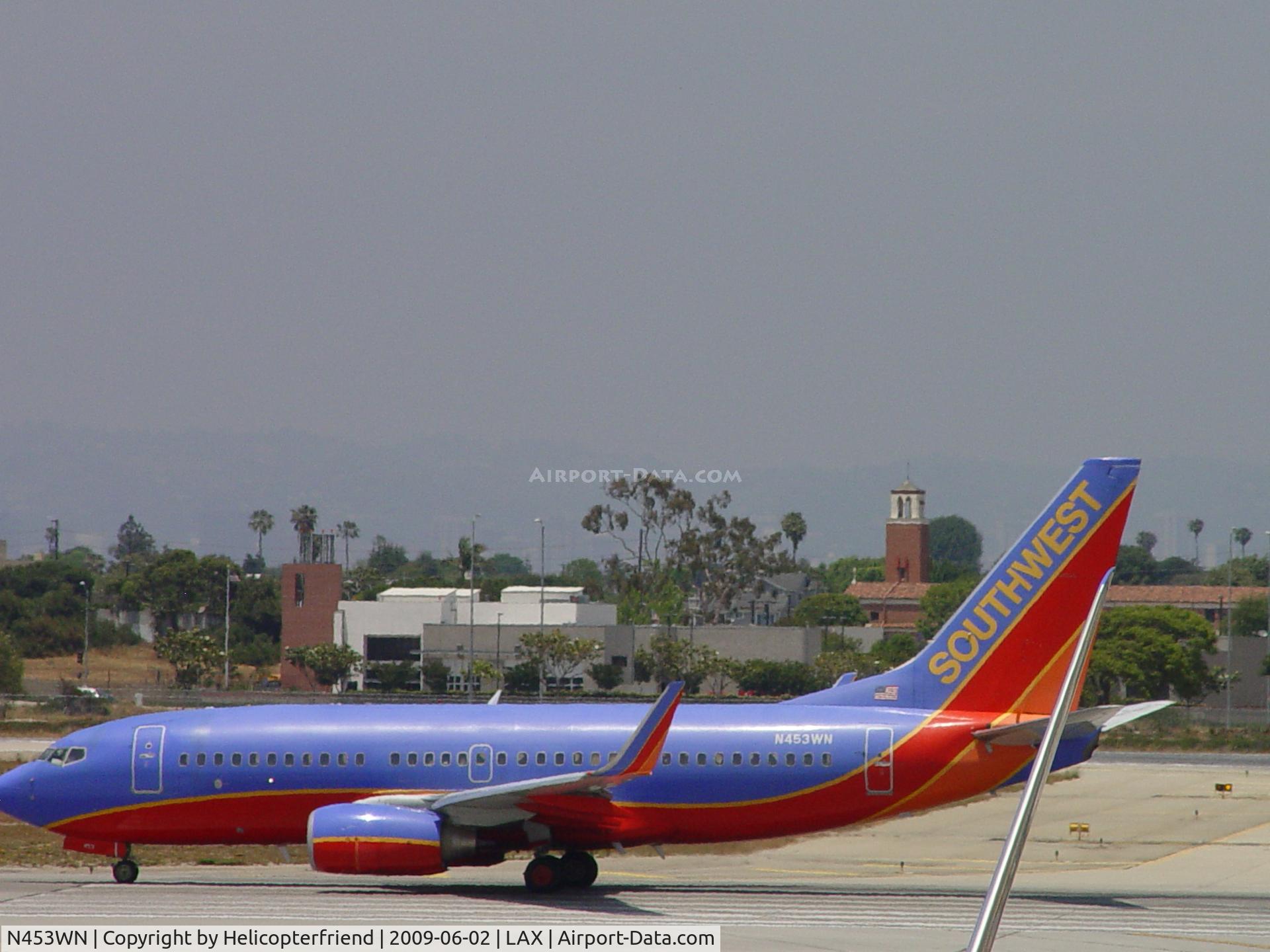 N453WN, 2004 Boeing 737-7H4 C/N 29847, Taking off on Runway 24L as seen from Terminal 1