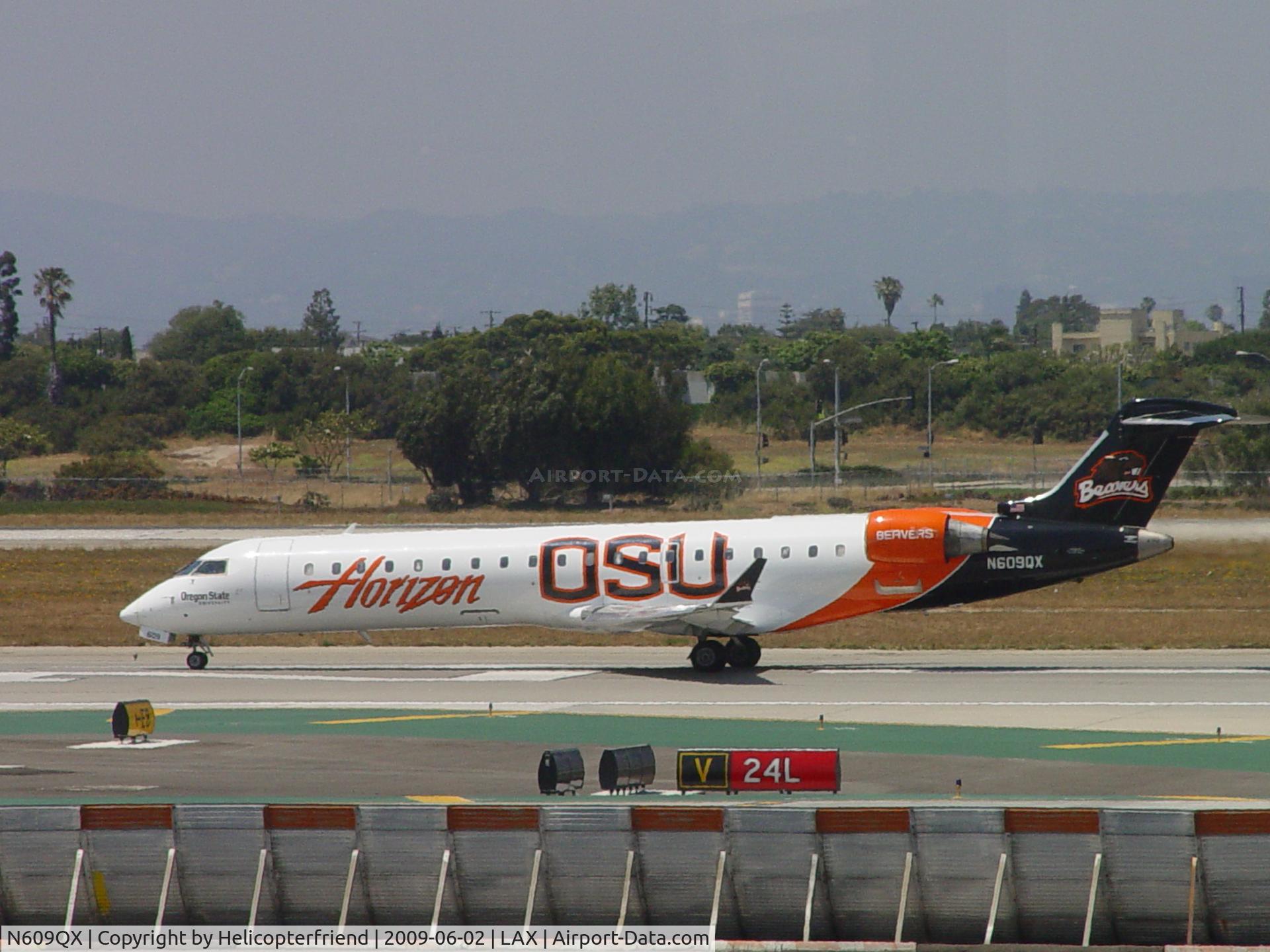 N609QX, 2001 Bombardier CRJ-701 (CL-600-2C10) Regional Jet C/N 10031, Starting to roll westbound on Runway 24L