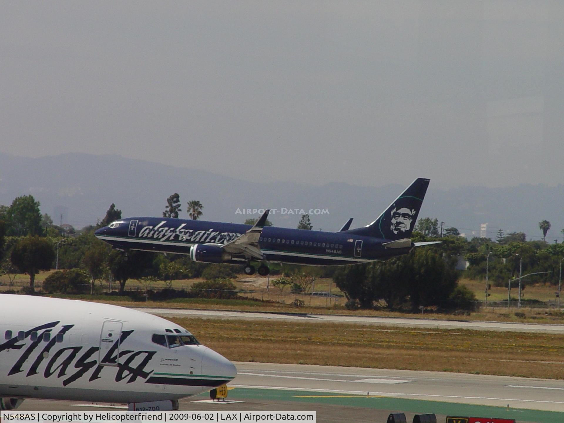 N548AS, 2005 Boeing 737-890 C/N 30020, Landing on 24R while passing Alaska N612AS