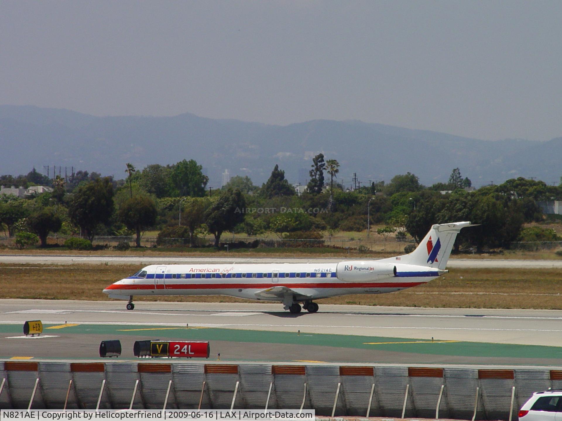 N821AE, 2002 Embraer ERJ-140LR (EMB-135KL) C/N 145577, Taking off on 24L
