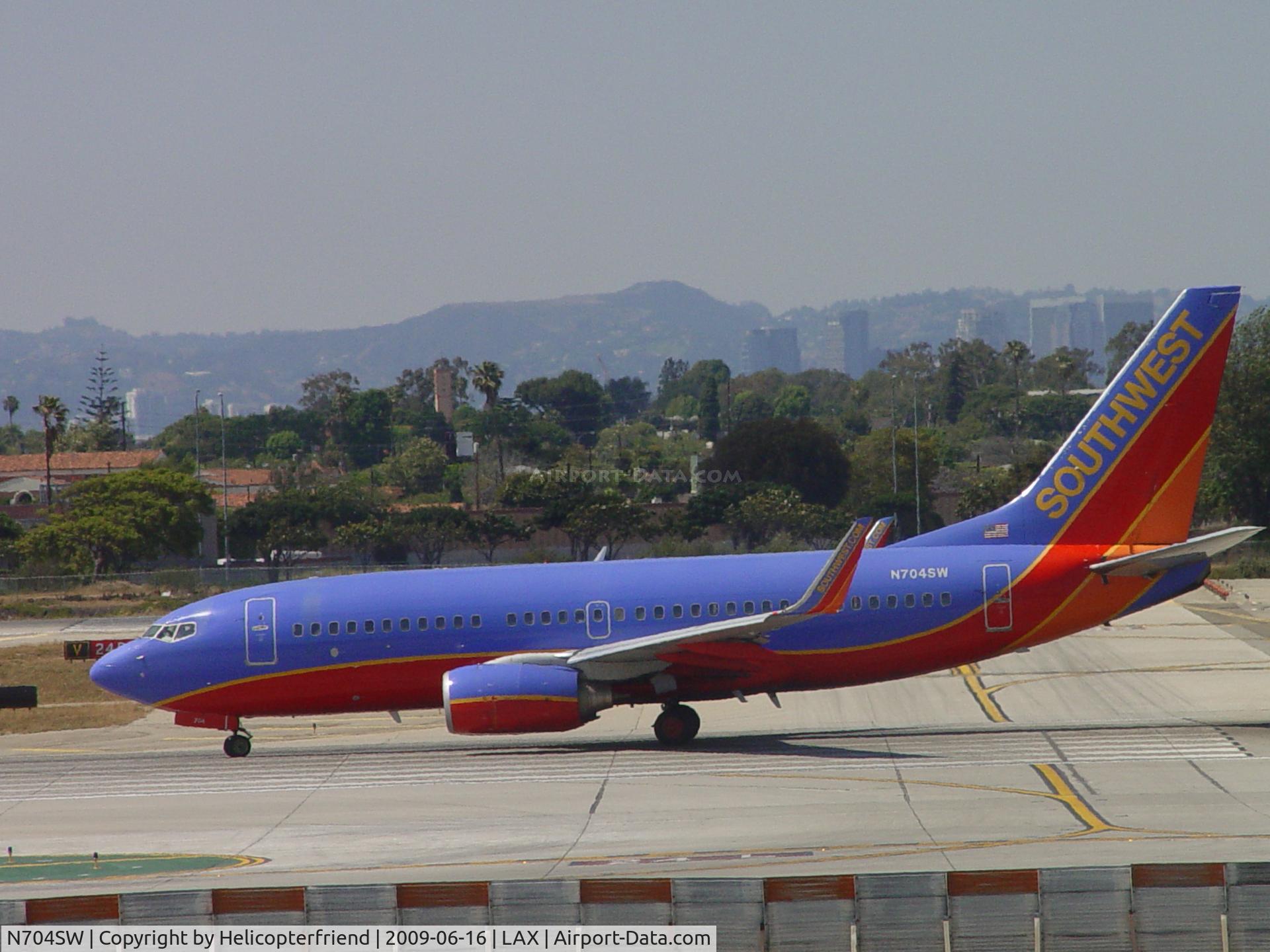 N704SW, 1998 Boeing 737-7H4 C/N 27838, Waiting it's turn to start take off roll westbound 24L
